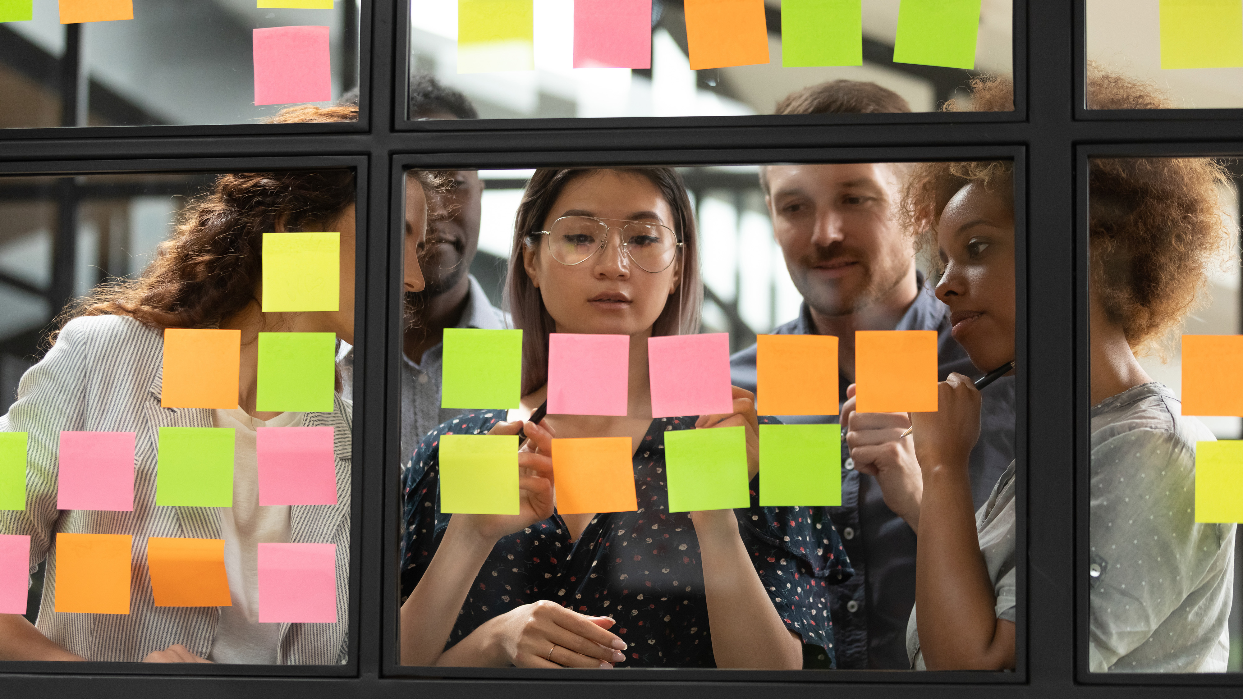 Diverse employees using post-its