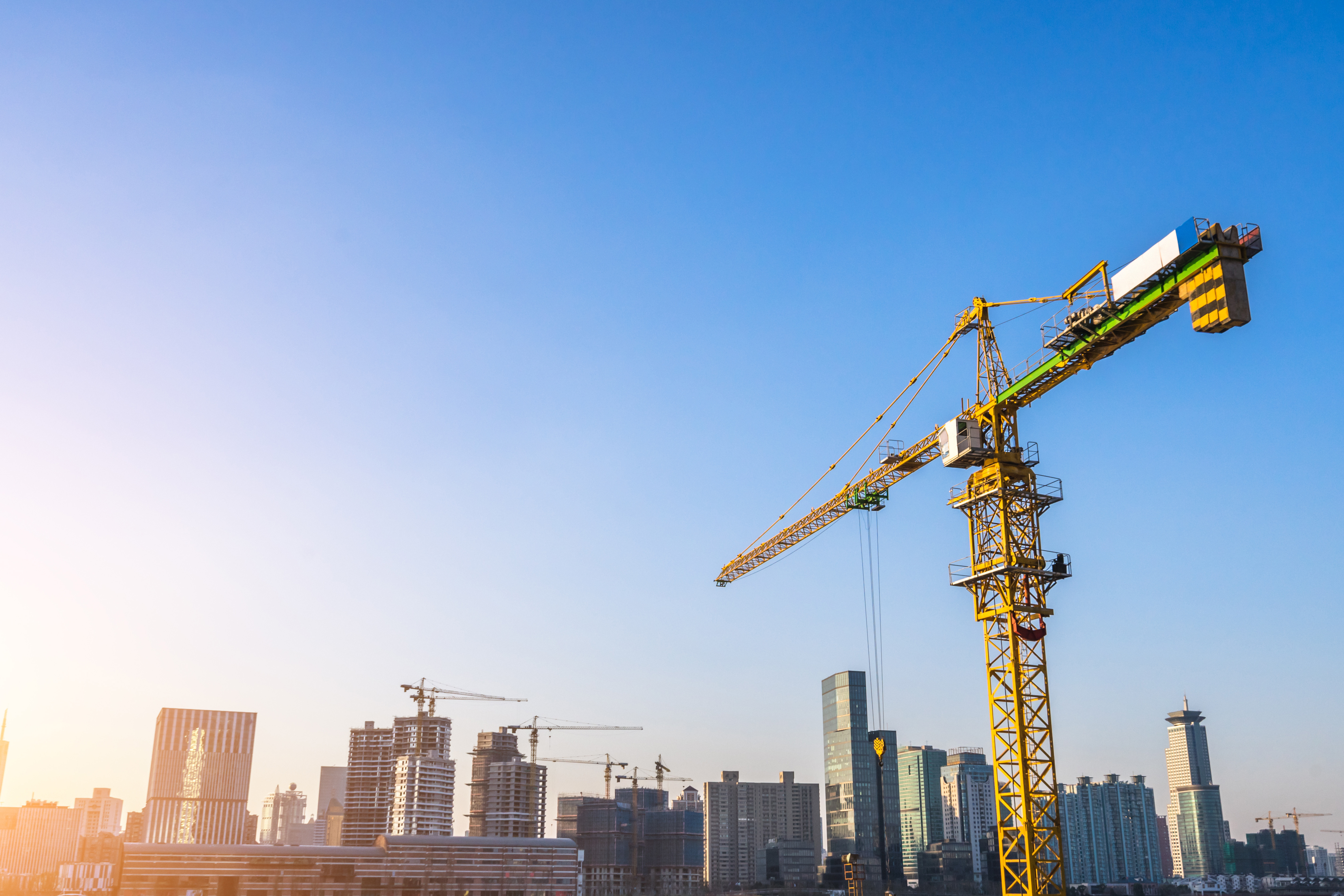 Crane above city skyline